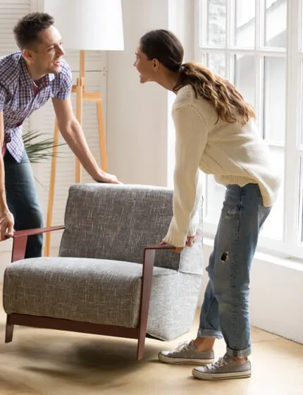 Couple moving couch | Flooring By Design