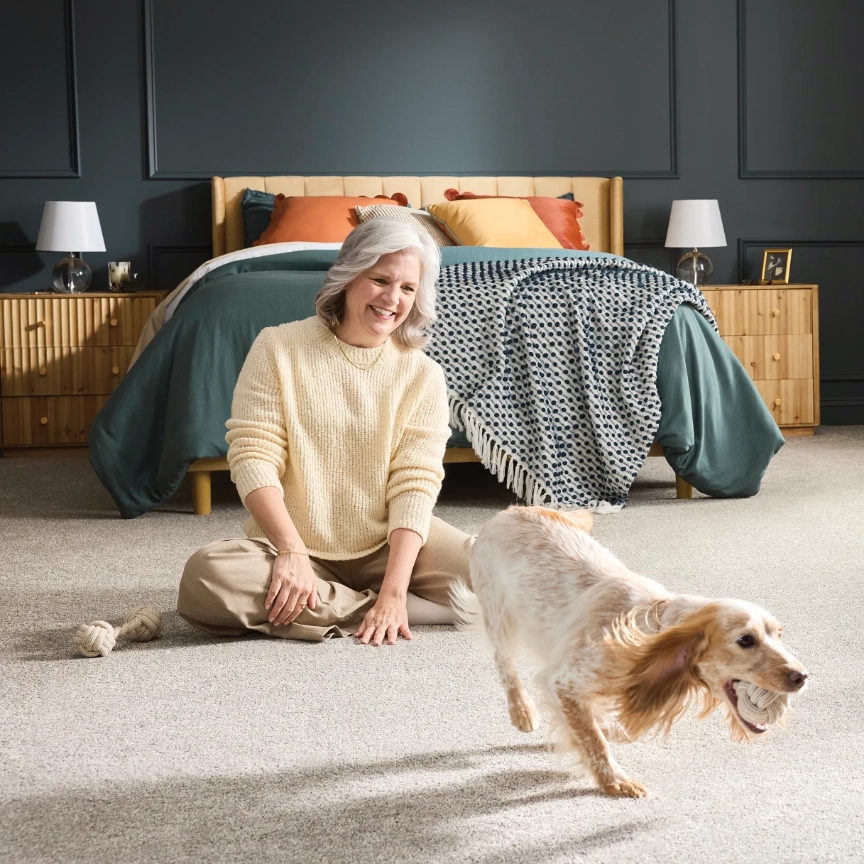 Lady playing with pet | Flooring By Design