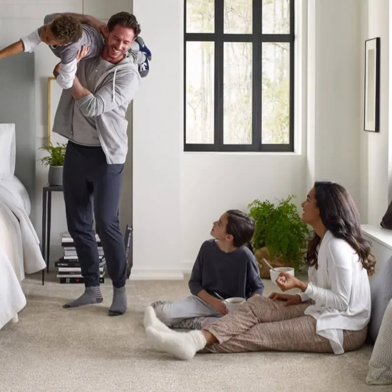 Family enjoying sitting on soft carpet | Flooring By Design