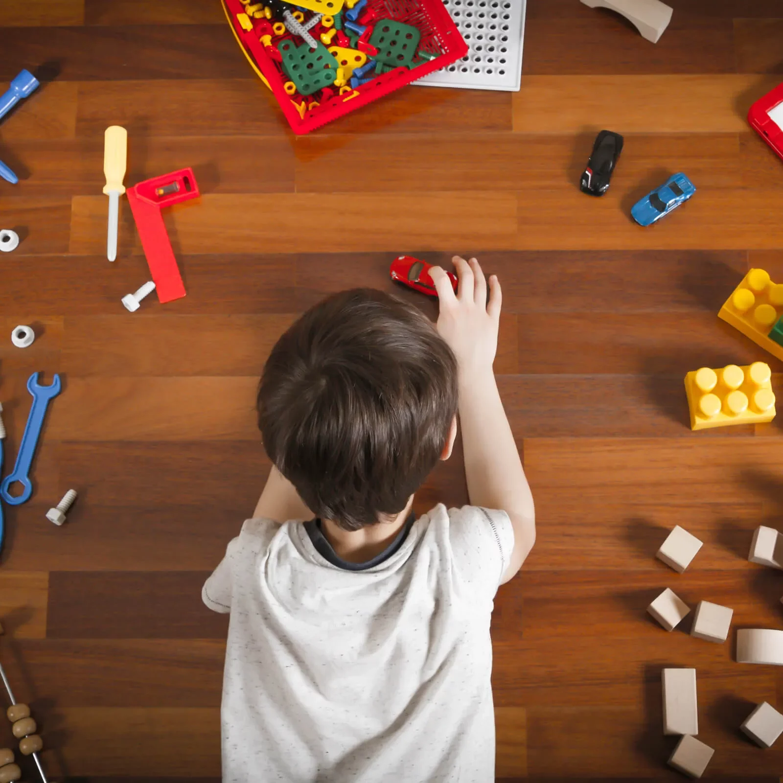 Kid playing with toycars | Flooring By Design